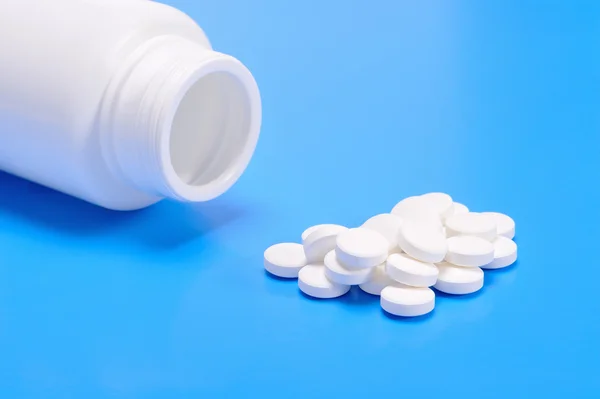 Pills spilling from a prescription medicine bottle