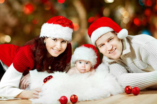 Christmas family of three persons in red hats
