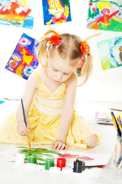 Creative child drawing with brush gouache colors