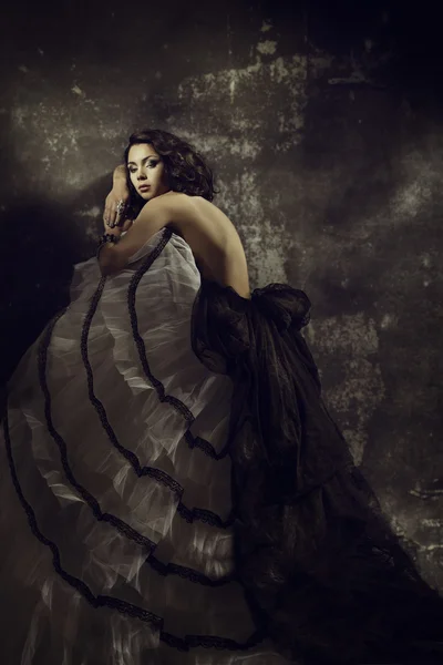 Woman beauty fashion dress, girl in draped gown over artistic grunge dark background