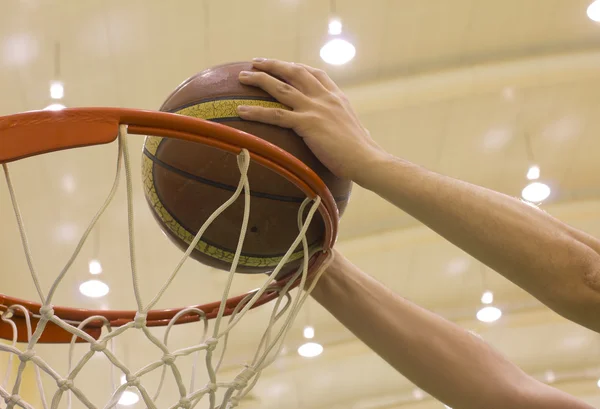 Scoring basket in basketball court