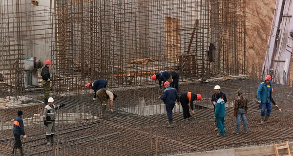 Construction workers busy with forwork frames