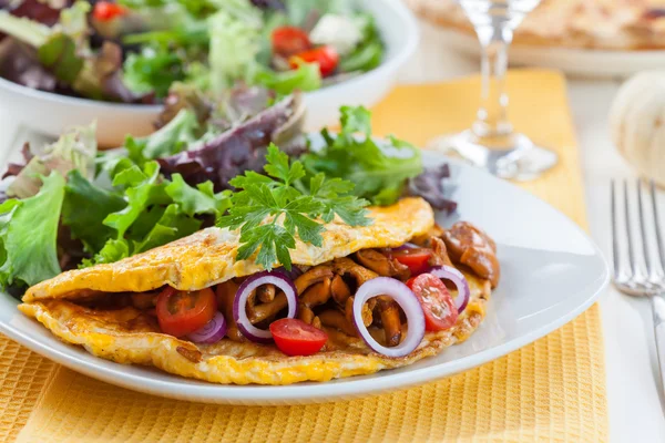 Omelet filled with chanterelle mushrooms