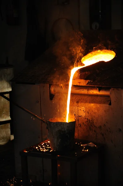 Foundry - Molten metal poured from lathe for casting