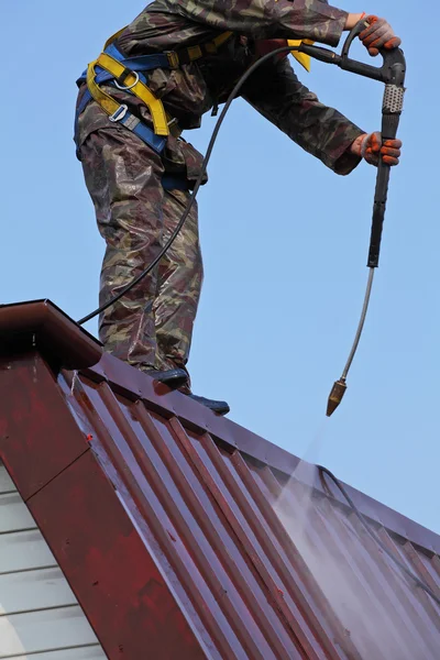 Worker on top of roof