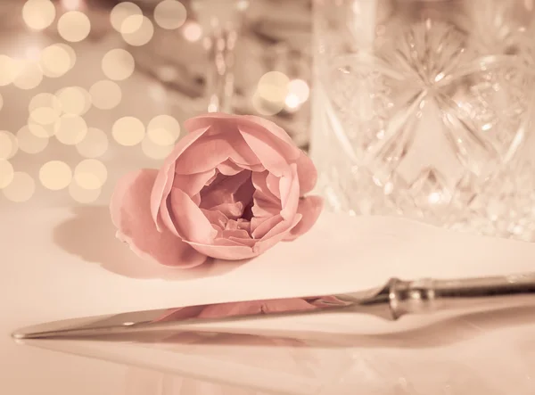 Elegant and romantic dinner setting with rose decoration and lights