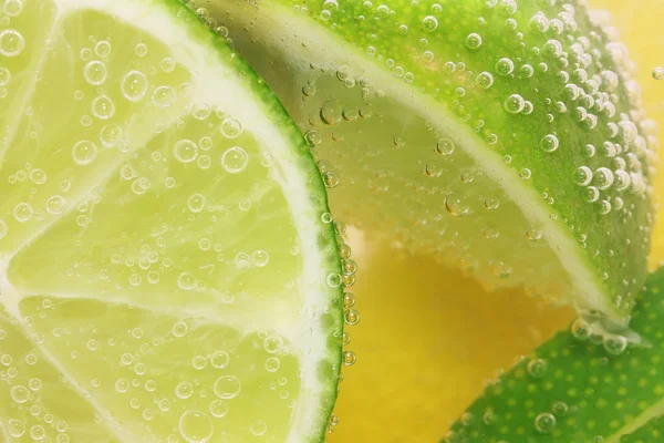 Lemon and lime slices in water