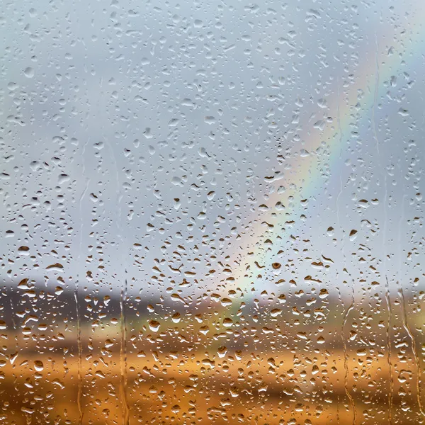Rainbow through rained window