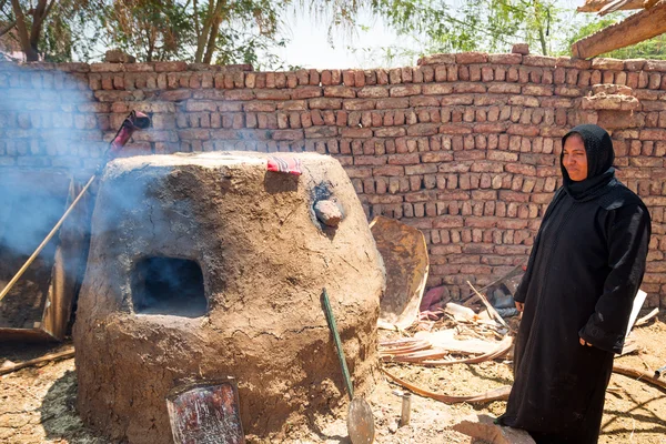 Arabic woman baking bread in the bedouin village