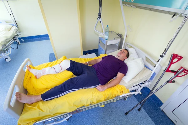 Man lying in hospital after surgery