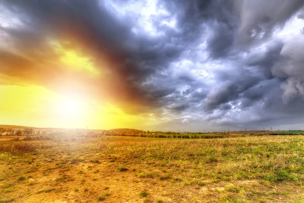 Cloudy sunset over the meadow