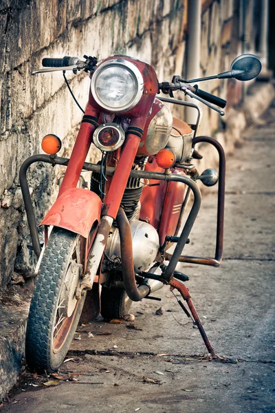 Old red and rusty vintage motorbike