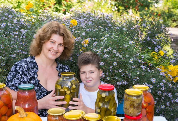 Mom with her son and home canned vegetables