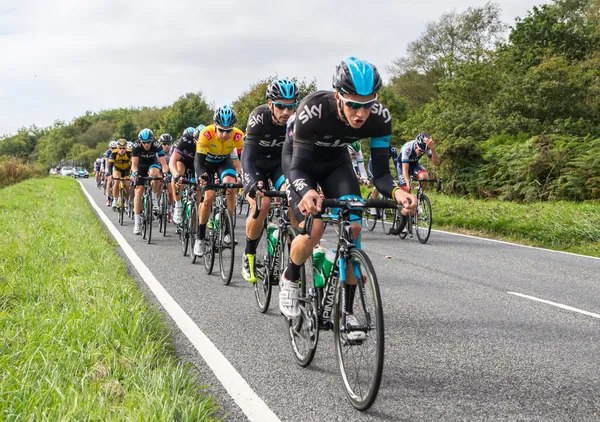 HONITON, UK - SEPTEMBER 20: Bradley Wiggins wears the IG Yellow Jersey as current tour leader, in the pack of the Devon stage of the Tour of Britain cycle race on September 20, 2013 in Honiton, UK