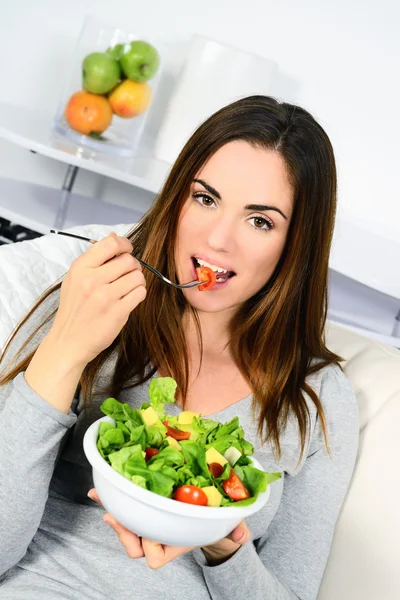 Woman eating salad.