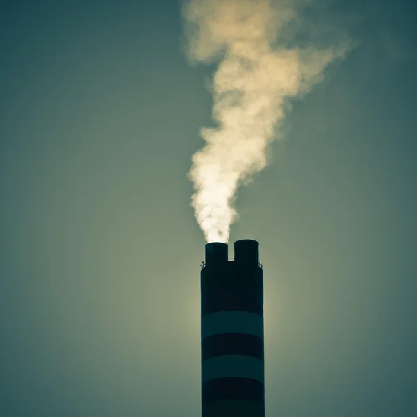 Industrial factory chimney with smoke