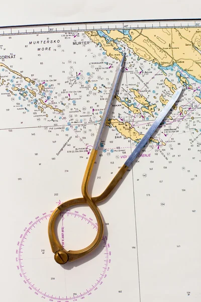 Pair of compasses for navigation on a sea map