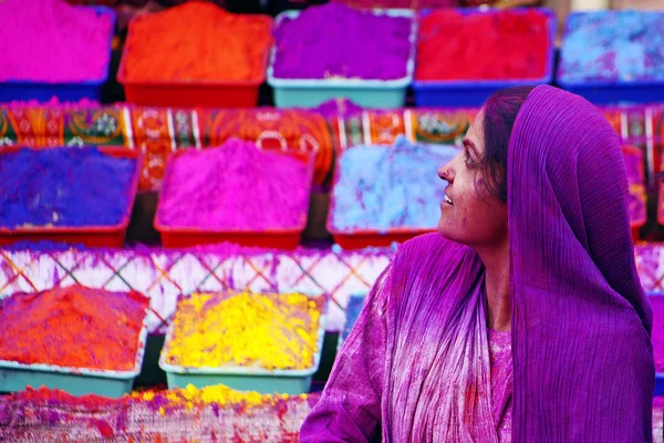 Lady in violet, covered in paint on Holi festival