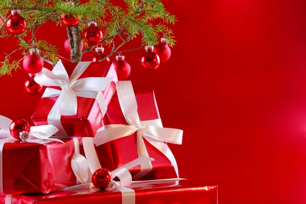 Elegant red gifts under tree