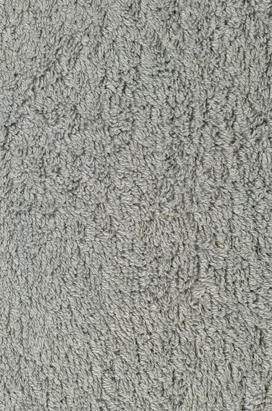 Grey natural plush terry cloth turkish bath beach towel, textured fabric macro background closeup vertical texture pattern