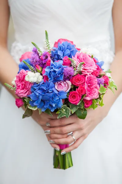 Beautiful wedding bouquet in hands of the bride