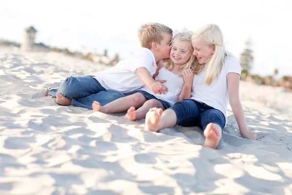 Adorable Sibling Children Kissing the Youngest