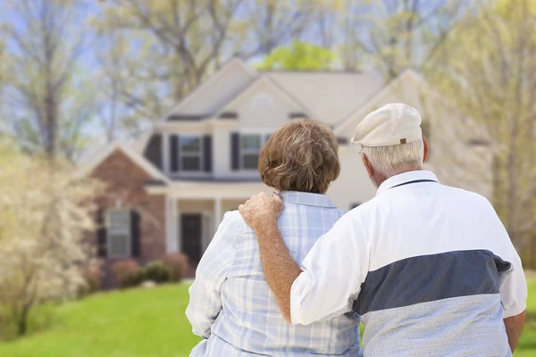 Happy Senior Couple Looking at Front of House