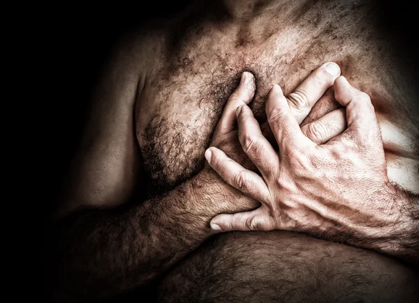 Shirtless man suffering from chest pain