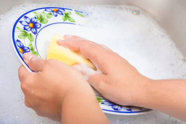 Washing the dishes on soapy water