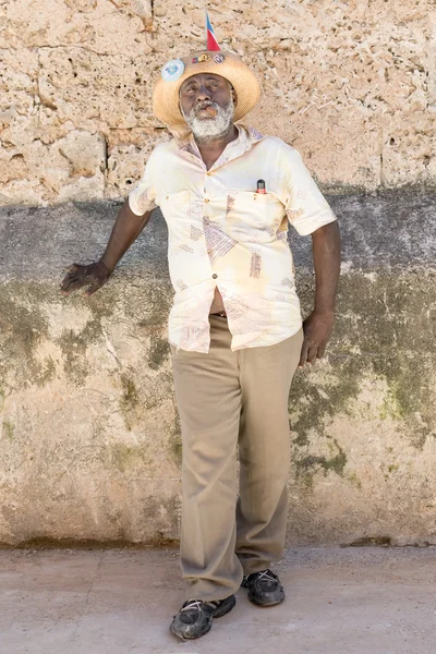 Old black man smoking a cuban cigar in Old Havana