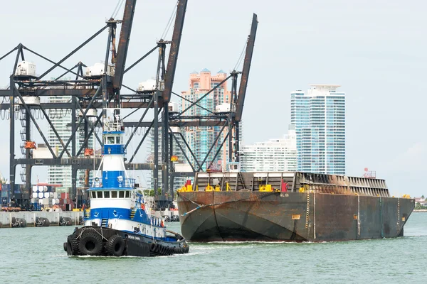 Tugboat pulling a barge in the Port of Miami