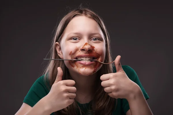 Teen girl with fork in her teeth