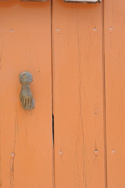 Orange door with knocker