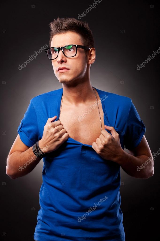 Aleesha+Young+Shirt+Ripping Young man ripping his blue shirt — Stock Photo © feedough #12561454
