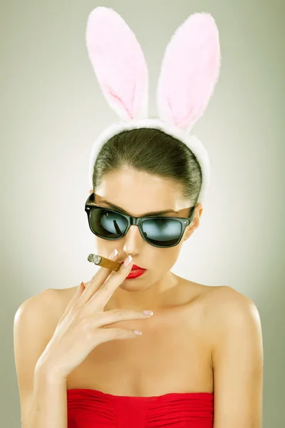Bunny woman smoking on a big cigar