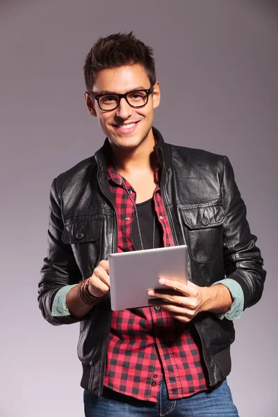 Happy young casual man with tablet