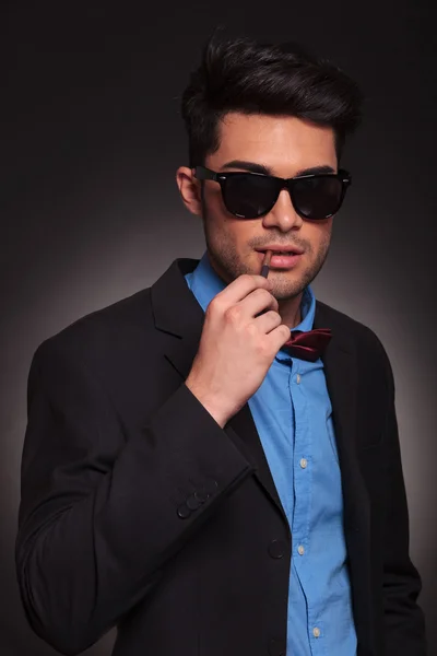 Fashion man with sunglasses ready for smoking