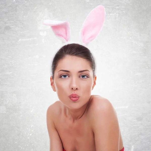 Woman wearing cute bunny sending a kiss