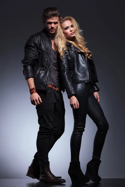 Full body picture of a man and woman in leather clothes