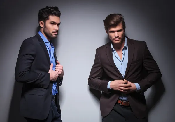 Two male fashion models posing in studio
