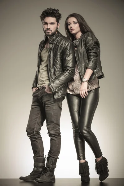 Fashion couple in casual leather jackets posing