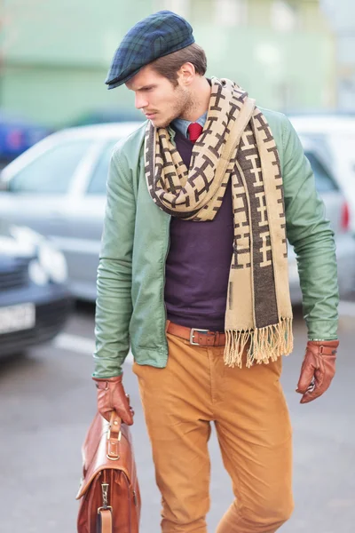 Side view of an elegant young fashionable man posing