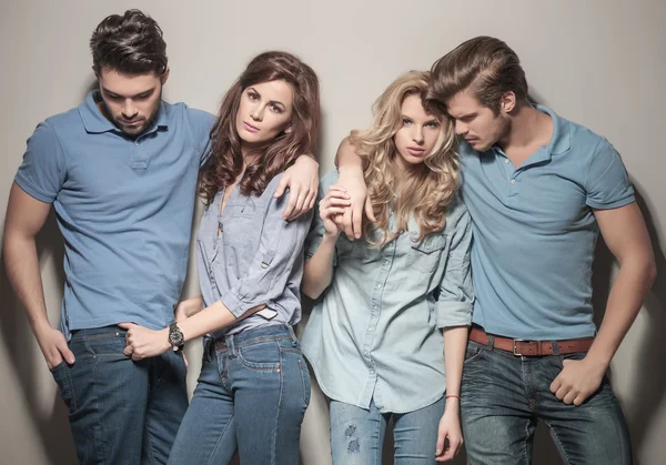 Men and women standing together in casual jeans clothes