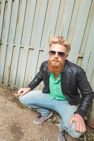 Young squatted bearded man