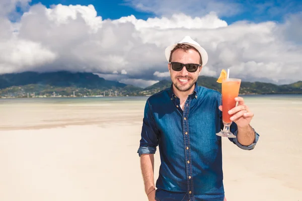 Man invites you to a cold drink on the beach