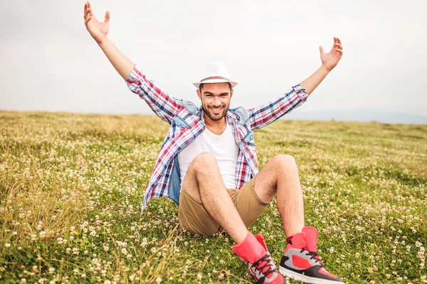 Young casual man celebrates success