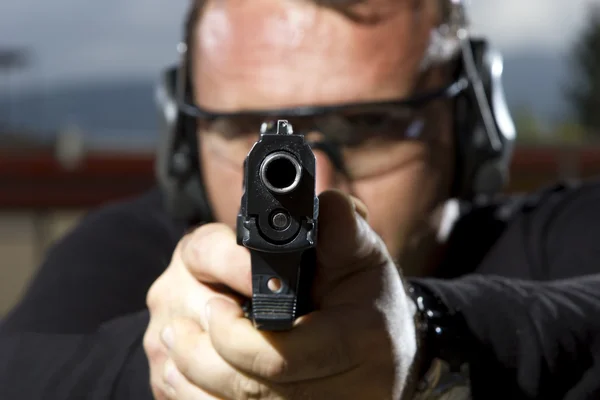 Man shooting on an outdoor shooting range