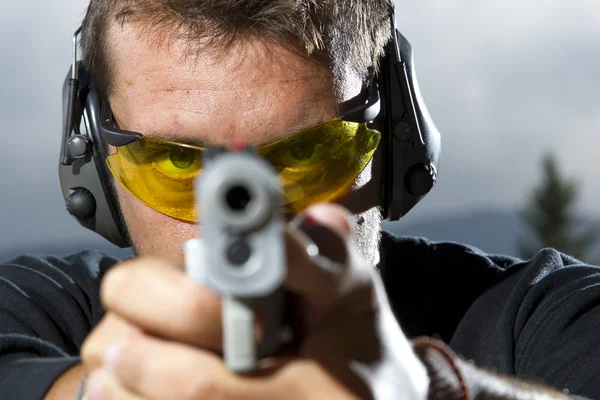 Man shooting on an outdoor shooting range