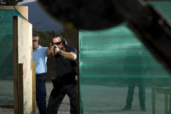 Man shooting on an outdoor shooting range