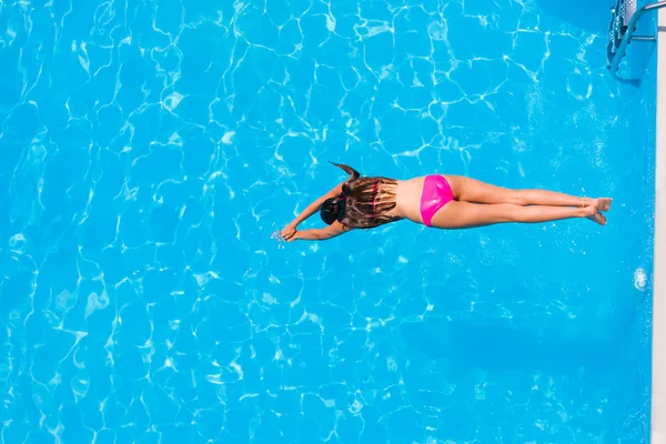 Girl diving in the swimming pool